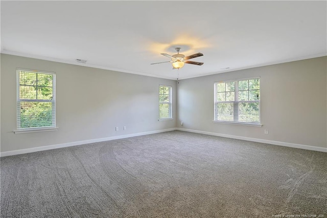 unfurnished room featuring baseboards, ceiling fan, carpet flooring, and ornamental molding