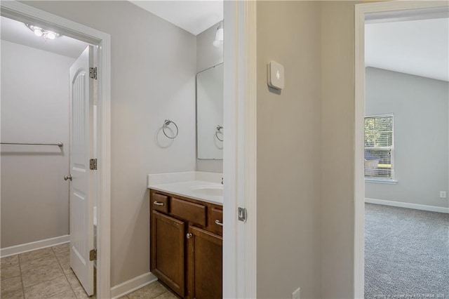 bathroom featuring baseboards and vanity