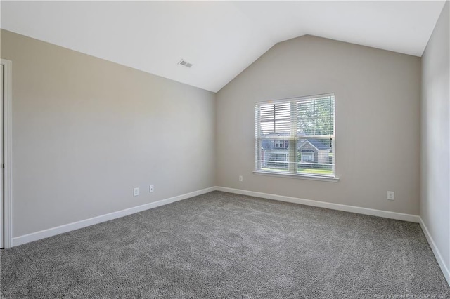 unfurnished room with lofted ceiling, carpet, and baseboards