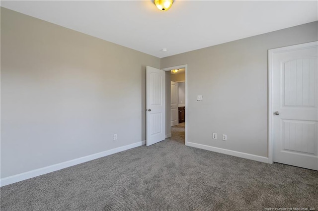 unfurnished bedroom featuring carpet floors and baseboards