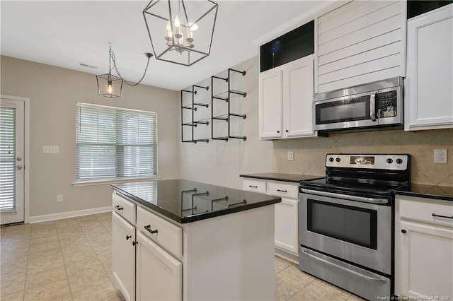 kitchen with appliances with stainless steel finishes, tasteful backsplash, white cabinetry, a center island, and hanging light fixtures