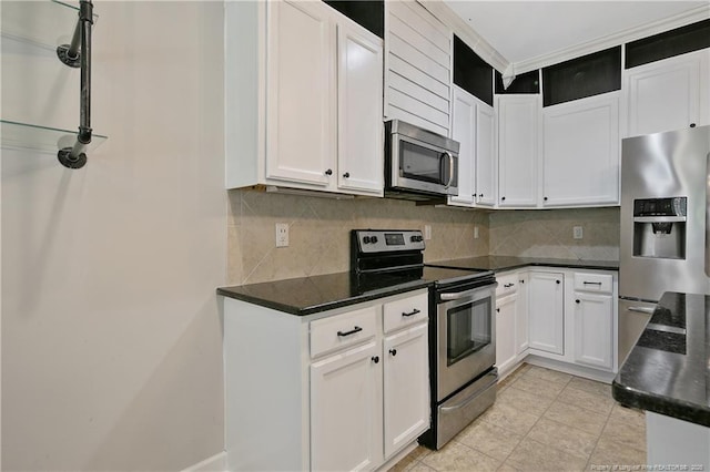 kitchen with stainless steel appliances, backsplash, and white cabinets
