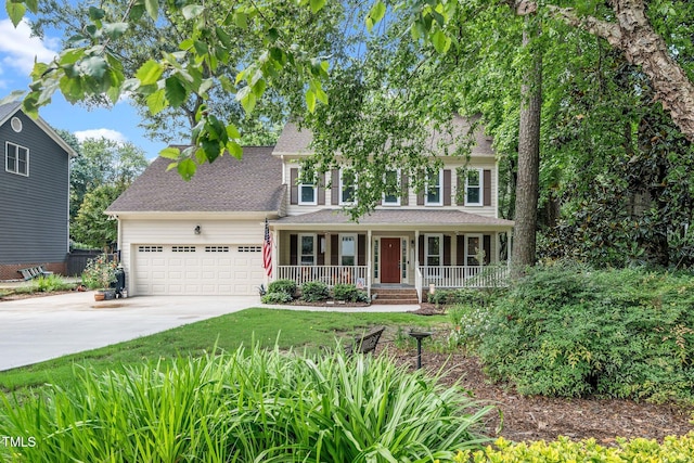 203 W Hill Dr, Cary, NC 27519 - view of front facade with covered porch, concrete driveway, an attached garage, and a shingled roof
