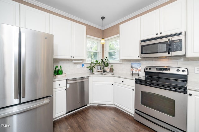 203 W Hill Dr, Cary, NC 27519 - kitchen with stainless steel appliances, white cabinets, backsplash, dark wood-style flooring, and ornamental molding