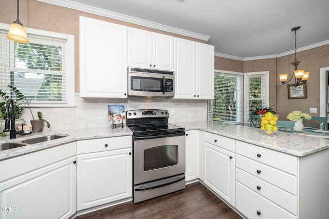 203 W Hill Dr, Cary, NC 27519 - kitchen featuring stainless steel appliances, a peninsula, tasteful backsplash, white cabinetry, and crown molding