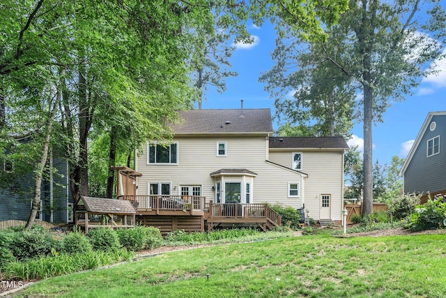 203 W Hill Dr, Cary, NC 27519 - back of property featuring a deck, a lawn, and a shingled roof