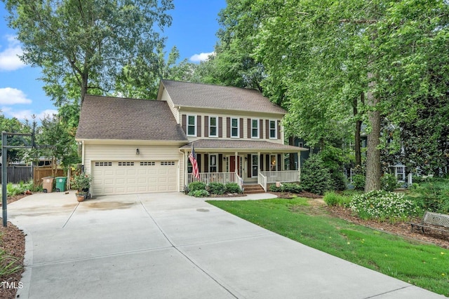 203 W Hill Dr, Cary, NC 27519 - colonial house with a porch, concrete driveway, a garage, and a shingled roof