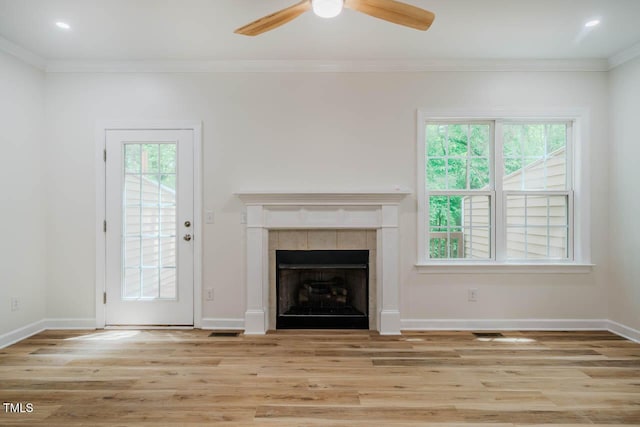 unfurnished living room featuring plenty of natural light, a ceiling fan, wood finished floors, crown molding, and recessed lighting