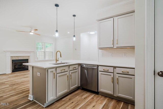 361 Anterbury Dr, Apex, NC 27502 - kitchen featuring stainless steel dishwasher, a peninsula, gray cabinets, a sink, and open floor plan