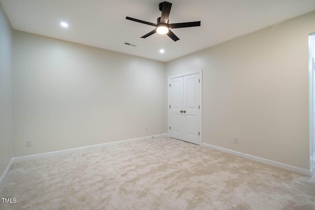 empty room featuring light carpet, a ceiling fan, baseboards, and recessed lighting