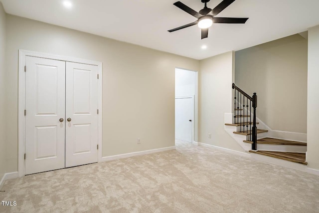 unfurnished bedroom with carpet, baseboards, a closet, and ceiling fan