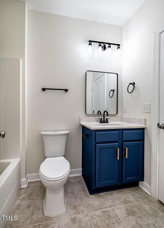 full bath featuring vanity, toilet, baseboards, and tile patterned flooring