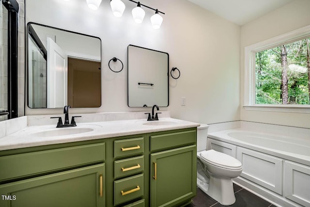 bathroom featuring a garden tub, double vanity, tile patterned floors, toilet, and a shower