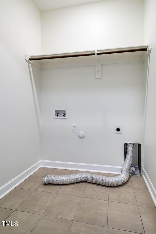 washroom with electric dryer hookup, hookup for a washing machine, hookup for a gas dryer, tile patterned floors, and baseboards