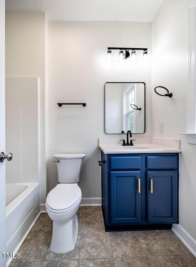 full bathroom with baseboards, vanity, and toilet