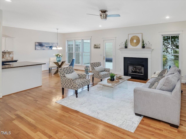 102 Westside Dr, Chapel Hill, NC 27516 - living room with a ceiling fan, light wood-style floors, a fireplace, a chandelier, and recessed lighting