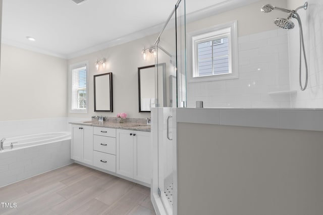 1423 Tannin Dr, Durham, NC 27713 - full bath with a stall shower, double vanity, a bath, wood finished floors, and ornamental molding