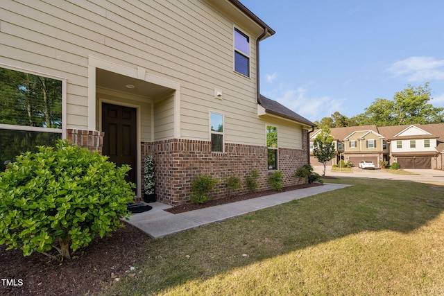 310 Alamosa Pl, Cary, NC 27519 - view of side of home featuring brick siding and a yard