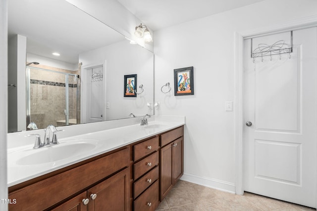 310 Alamosa Pl, Cary, NC 27519 - full bath featuring a stall shower, double vanity, tile patterned flooring, and baseboards