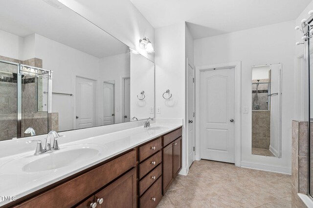 310 Alamosa Pl, Cary, NC 27519 - bathroom featuring a shower stall, double vanity, and tile patterned flooring