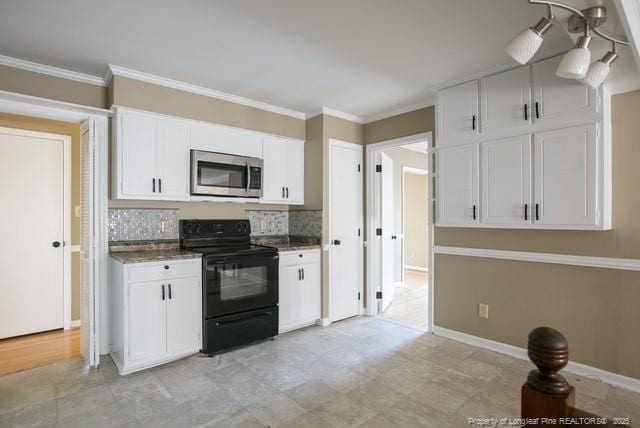 kitchen featuring stainless steel microwave, black range with electric cooktop, crown molding, tasteful backsplash, and white cabinetry