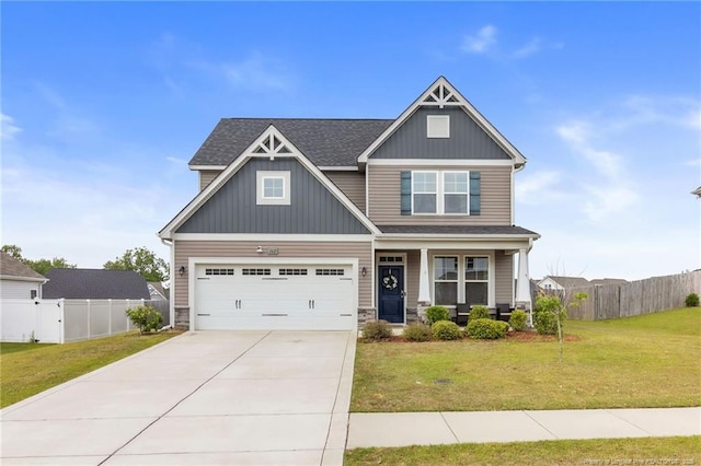craftsman inspired home featuring concrete driveway, a porch, a garage, board and batten siding, and roof with shingles