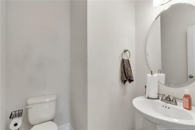 half bathroom with a sink and toilet