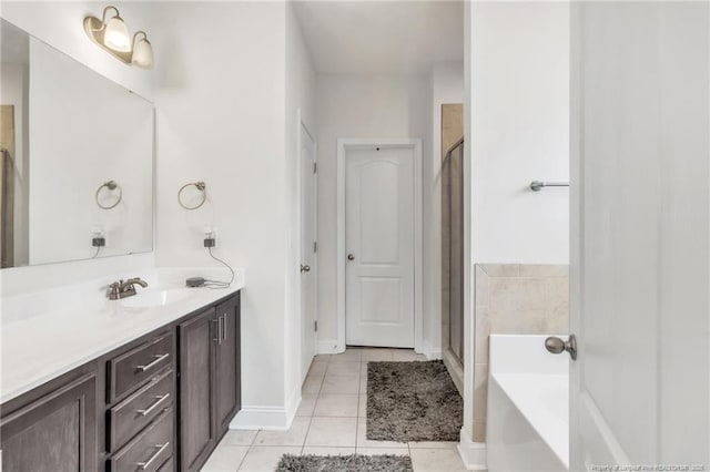 bathroom featuring tile patterned floors, a stall shower, vanity, and a bath