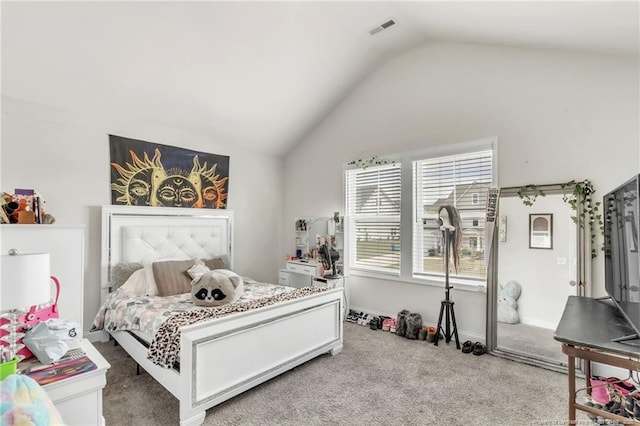 bedroom with lofted ceiling, light colored carpet, and baseboards