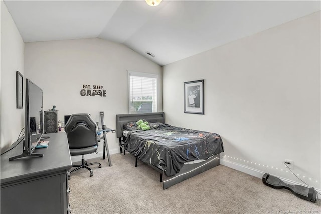 bedroom with lofted ceiling, carpet flooring, baseboards, and a desk