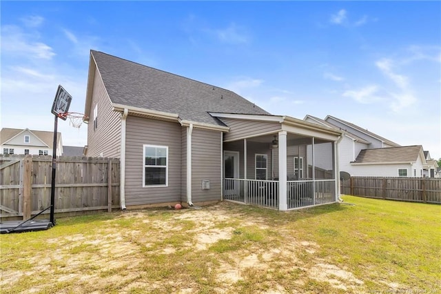 rear view of property featuring a sunroom and a shingled roof