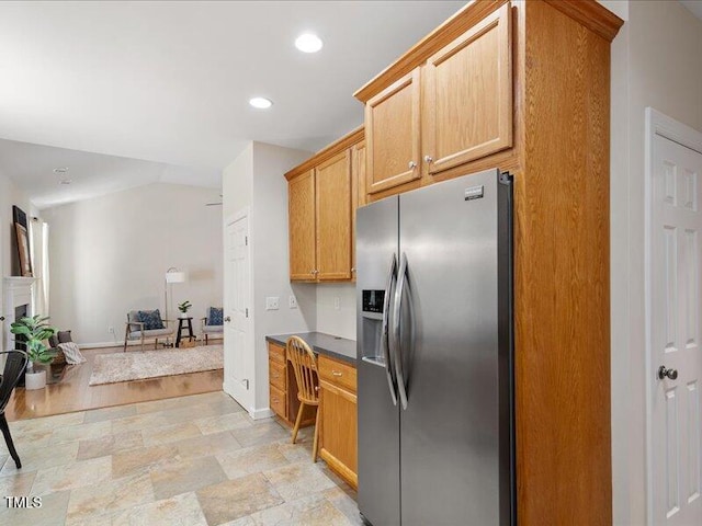 1662 Beechaven Rd, Fuquay Varina, NC 27526 - kitchen with stainless steel fridge with ice dispenser, baseboards, dark countertops, recessed lighting, and stone finish floors