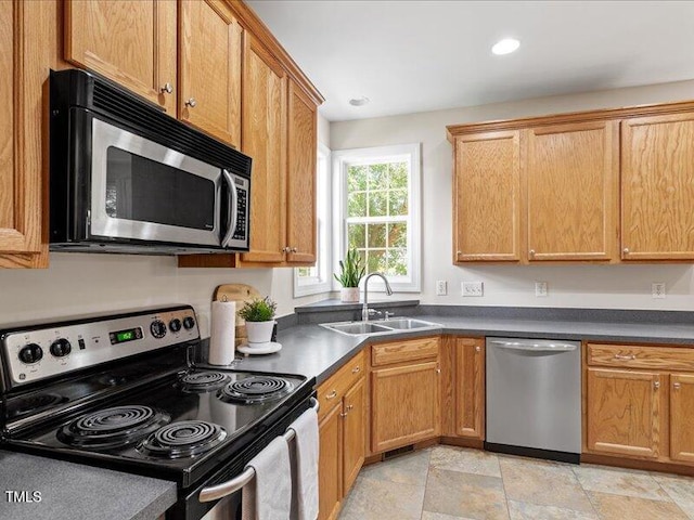 1662 Beechaven Rd, Fuquay Varina, NC 27526 - kitchen with stainless steel appliances, a sink, dark countertops, recessed lighting, and light stone finish floors