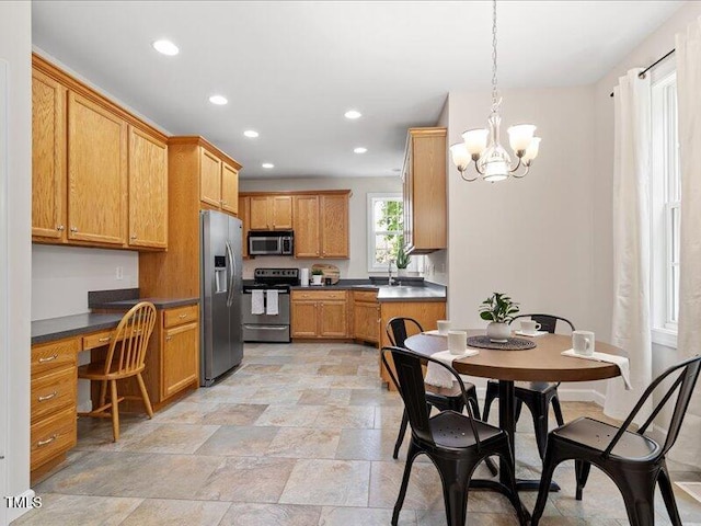 1662 Beechaven Rd, Fuquay Varina, NC 27526 - kitchen with appliances with stainless steel finishes, recessed lighting, dark countertops, a sink, and a chandelier