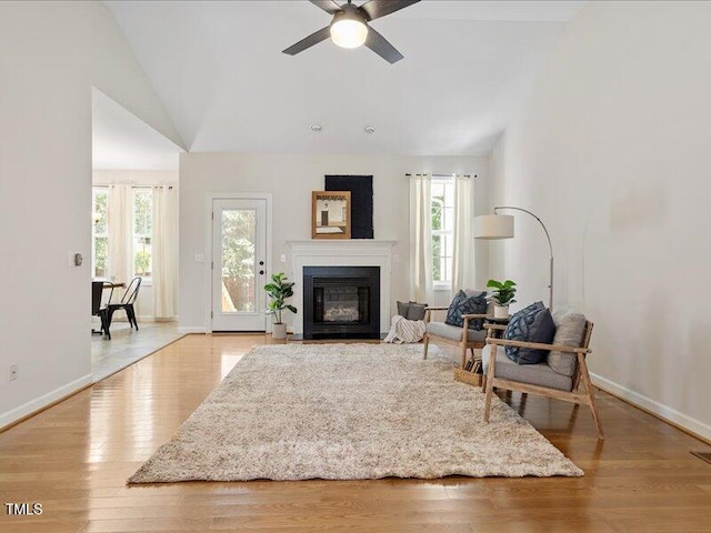 1662 Beechaven Rd, Fuquay Varina, NC 27526 - living room featuring plenty of natural light, ceiling fan, a fireplace with flush hearth, light wood-style flooring, and high vaulted ceiling