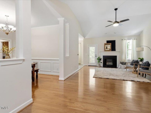 1662 Beechaven Rd, Fuquay Varina, NC 27526 - living area with a ceiling fan, light wood-style floors, high vaulted ceiling, a chandelier, and a glass covered fireplace