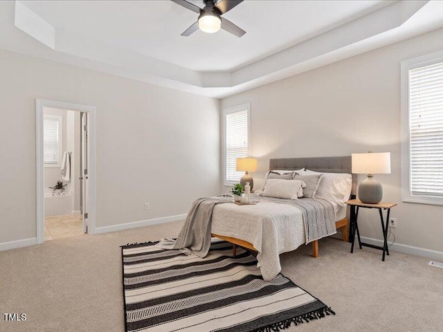 1662 Beechaven Rd, Fuquay Varina, NC 27526 - carpeted bedroom with a tray ceiling, multiple windows, and baseboards