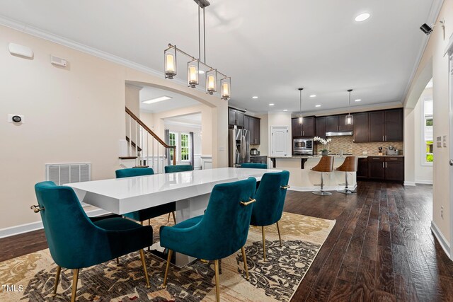 200 Vintage Hill Cir, Apex, NC 27539 - dining area featuring dark wood-style floors, recessed lighting, arched walkways, ornamental molding, and baseboards