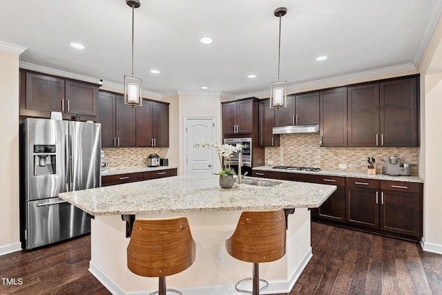 200 Vintage Hill Cir, Apex, NC 27539 - kitchen with stainless steel appliances, under cabinet range hood, dark brown cabinets, tasteful backsplash, and ornamental molding