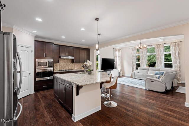 200 Vintage Hill Cir, Apex, NC 27539 - kitchen featuring appliances with stainless steel finishes, open floor plan, under cabinet range hood, crown molding, and a chandelier