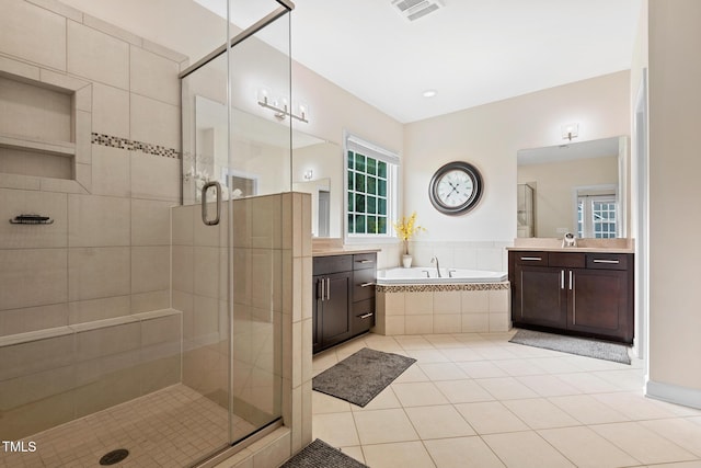 200 Vintage Hill Cir, Apex, NC 27539 - bathroom with vanity, a stall shower, tile patterned flooring, a garden tub, and healthy amount of natural light