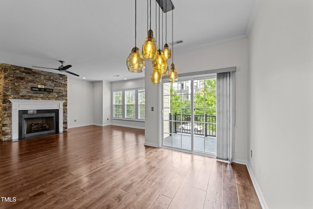 9164 Wooden Rd, Raleigh, NC 27617 - unfurnished living room featuring ceiling fan, wood finished floors, a stone fireplace, baseboards, and ornamental molding