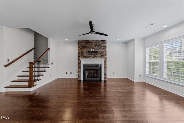 9164 Wooden Rd, Raleigh, NC 27617 - unfurnished living room featuring a ceiling fan, hardwood / wood-style flooring, a stone fireplace, stairs, and ornamental molding