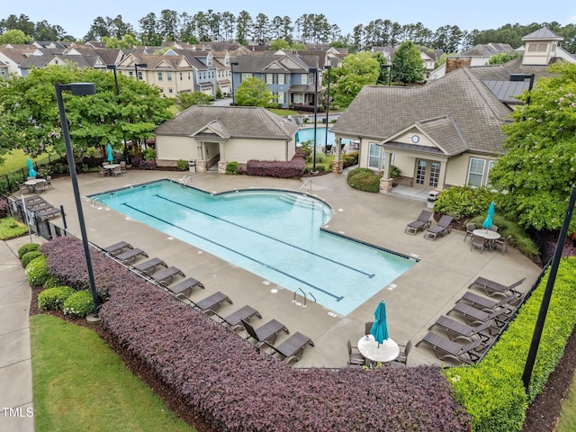 9164 Wooden Rd, Raleigh, NC 27617 - community pool featuring french doors, a patio, a residential view, and an outbuilding