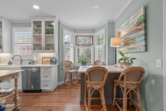 1813 Carrington Dr, Raleigh, NC 27615 - dining space featuring crown molding, healthy amount of natural light, light wood-style floors, recessed lighting, and bar