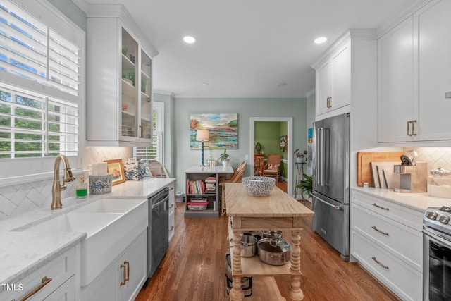 1813 Carrington Dr, Raleigh, NC 27615 - kitchen featuring appliances with stainless steel finishes, a sink, white cabinetry, backsplash, and recessed lighting
