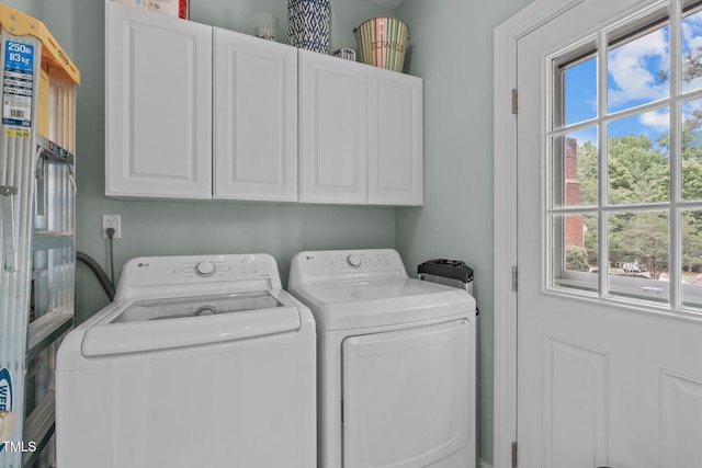 1813 Carrington Dr, Raleigh, NC 27615 - laundry room featuring independent washer and dryer, cabinet space, and healthy amount of natural light