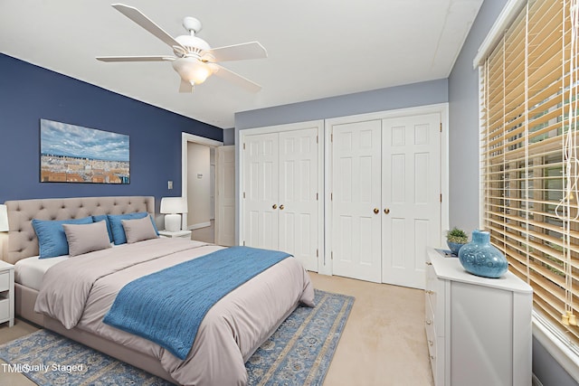 5804 Heatherbrook Cir, Raleigh, NC 27612 - bedroom with multiple closets, light colored carpet, and a ceiling fan