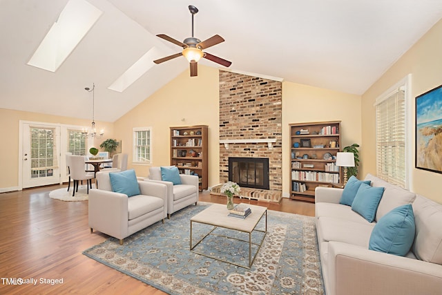 5804 Heatherbrook Cir, Raleigh, NC 27612 - living area with a skylight, wood finished floors, ceiling fan, a chandelier, and high vaulted ceiling