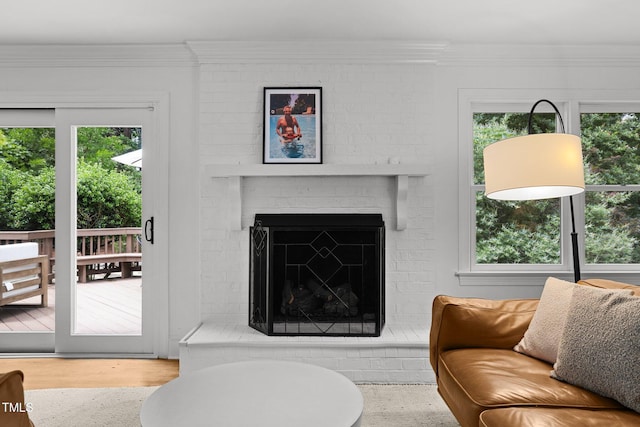 1706 Rangecrest Rd, Raleigh, NC 27612 - living room with healthy amount of natural light, a brick fireplace, crown molding, and wood finished floors